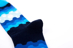 Detailed close-up showing the deep blue reinforced heel and woven texture of crew socks