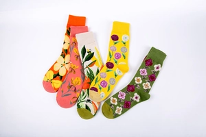 Detail view of five pairs of floral cotton mid-tube socks with ribbed cuffs and unique patterns