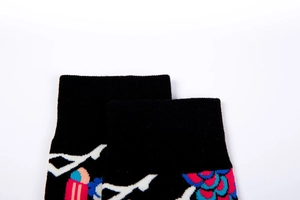 Detail of ribbed cuff and vibrant abstract pattern on trendy men's knit cotton socks