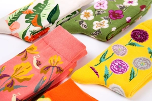 Detailed close-up of colorful floral patterned cotton socks with ribbed cuffs and vibrant designs