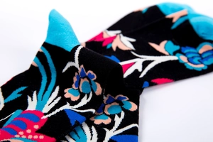 Macro detail of cotton socks with floral prints and contrast turquoise heel and toe