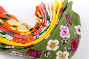 Detailed close-up of vibrant knitted socks featuring citrus and floral pattern textures