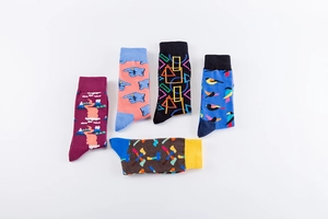 Detail of colorful cotton blend crew socks with creative graphic patterns and ribbed cuffs