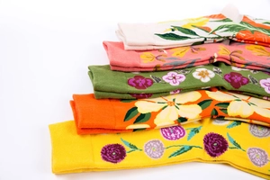 Close-up of colorful mid-calf socks with floral patterns and elastic ribbed cuffs