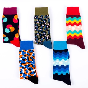 Five pairs of colorful crew socks with geometric patterns and rib cuffs on white background
