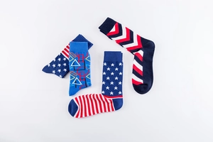 Detail shot of men's crew socks featuring American flag and geometric patterns in soft cotton