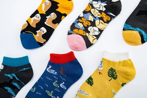 Detail view of assorted artistic printed ankle socks featuring various colorful patterns