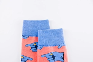 Detail of ribbed blue cuff and knit texture on colorful coral skateboard socks