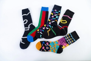 Macro view of five colorful patterned mid-calf socks showcasing diverse geometric designs