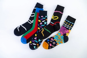 Flat lay of five mid-calf cotton socks with colorful pop art and geometric patterns