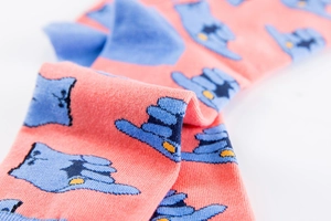 Detailed macro view of soft cotton knit socks featuring a blue finger gesture pattern