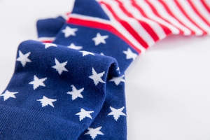 Close-up of knit crew socks featuring American flag stars and stripes pattern design