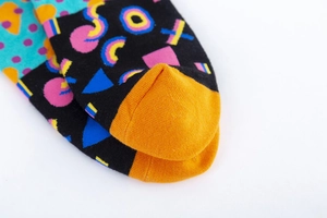 Detailed close-up of colorful Memphis style geometric patterns on cotton blend socks