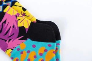 Detailed macro view showing the colorful geometric knit pattern and heel construction of the sock