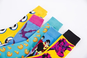 Vibrant colorful crew socks featuring pop art illustrations and ribbed cuffs on white back