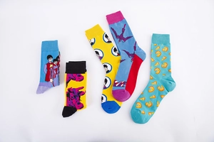 Detail of colorful cotton crew socks featuring artistic portraits and vibrant patterns