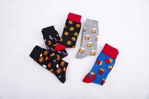 Detail of five pairs of men's cotton socks with fast food burger and fries patterns