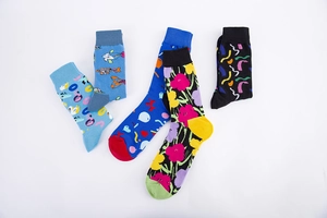 Flat lay of five pairs of colorful casual socks with creative floral and cartoon patterns