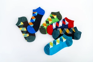 Close-up of vibrant argyle patterns and knit texture on colorful low-cut ankle socks