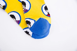 Detail of yellow knit socks featuring blue toe contrast and Prince portrait icons