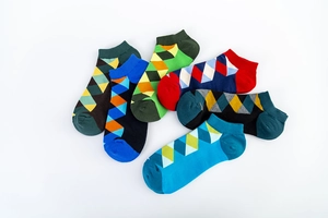 Detail of colorful argyle patterned low-cut ankle socks in a six-pair collection pack