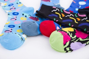 Close-up of colorful patterned cotton socks featuring flamingo and floral prints