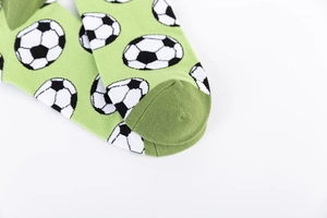 Macro detail of men's cotton crew socks showing football pattern and green toe stitching