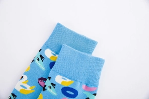 Detail of light blue cotton crew socks featuring colorful summer pool lifebuoy patterns