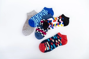 Detail of five assorted geometric pattern low cut cotton socks with ribbed elastic cuffs
