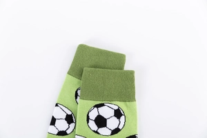 Detailed shot of green cotton socks with football patterns and ribbed cuffs for men