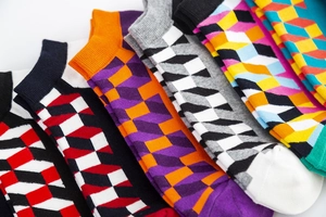 Detailed close-up of men's knit socks featuring colorful 3D geometric cube patterns