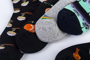 Detailed close-up of colorful mid-calf cotton socks with assorted printed patterns