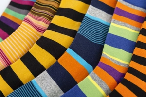 Detailed knit texture of colorful striped cotton crew socks for men in vibrant patterns