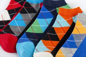 Close-up of colorful argyle pattern and elastic ribbed cuffs on cotton knit ankle socks