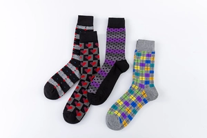 Detail of four pairs of men's crew socks featuring assorted geometric and stripe patterns