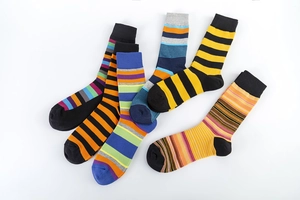 Detail view of colorful striped patterns and ribbed cuffs on knitted cotton crew socks