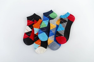 Detailed view of 5-pack men's ankle socks featuring colorful argyle patterns in soft cotton