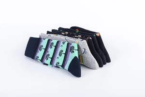 Close-up of assorted mid-calf cotton socks featuring palm trees and stripe patterns