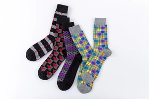 Detailed flat lay of five assorted patterned cotton blend crew socks for men