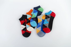 Flat lay of five pairs of colorful argyle pattern low-cut cotton socks for men