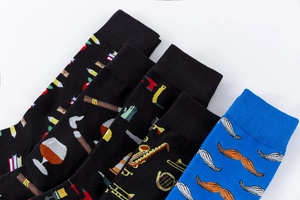 Detailed close-up of artistic cotton socks with novelty music and tool patterns