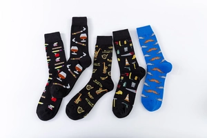 Detail view of five pairs of patterned cotton crew socks with vibrant artistic embroidery