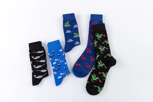Flat lay of five cotton crew socks featuring colorful narwhal, sushi, and dragon patterns