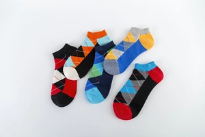 Close-up of five pairs of cotton argyle pattern ankle socks in various vibrant colors