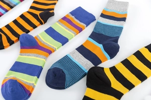 Macro shot of colorful striped cotton crew socks showcasing fine knit texture and patterns