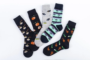 Flat lay of five mid-calf cotton socks featuring playful food and lifestyle prints