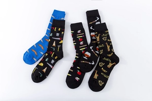Flat lay of artistic crew socks featuring mustache, construction, school and jazz patterns