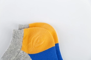 Close-up of colorful Argyle pattern men's cotton ankle socks with reinforced heel detail