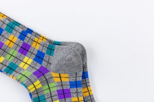Detailed view of the reinforced heel and colorful argyle pattern on men's mid-calf socks