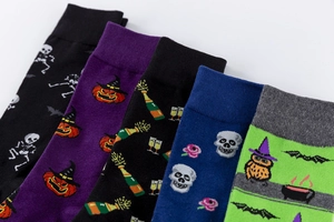 Detail of Halloween crew socks featuring pumpkins and bats on festive colorful fabrics